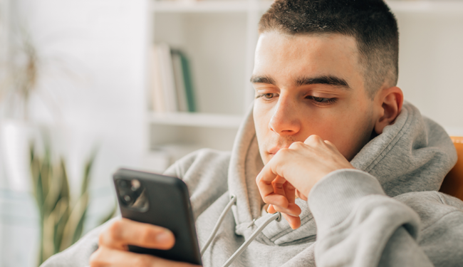teenage male on mobile